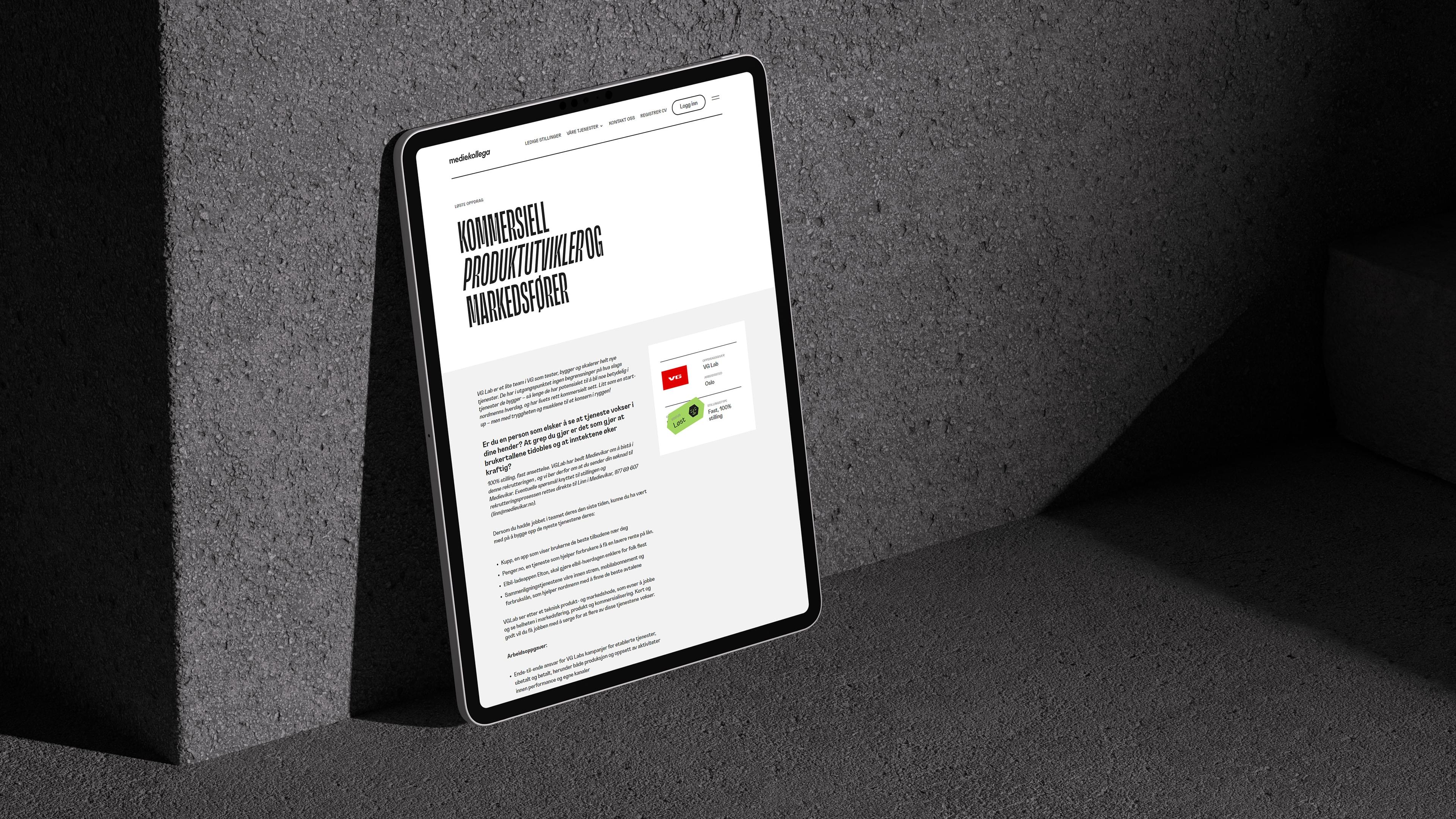 an ipad leaning against a wall with a screenshot of the mediekollega website